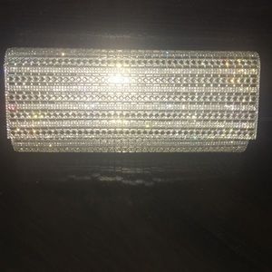 A gold clutch with a usable strap inside.